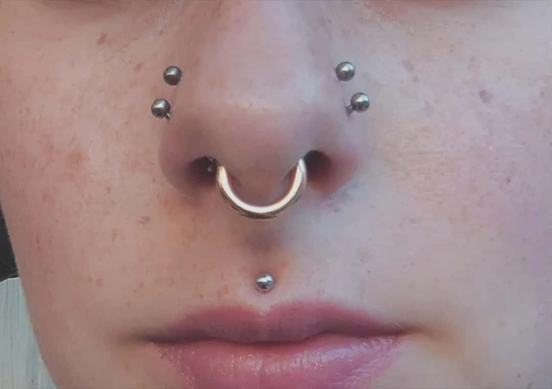Double nostril piercing with a low nostril piercing