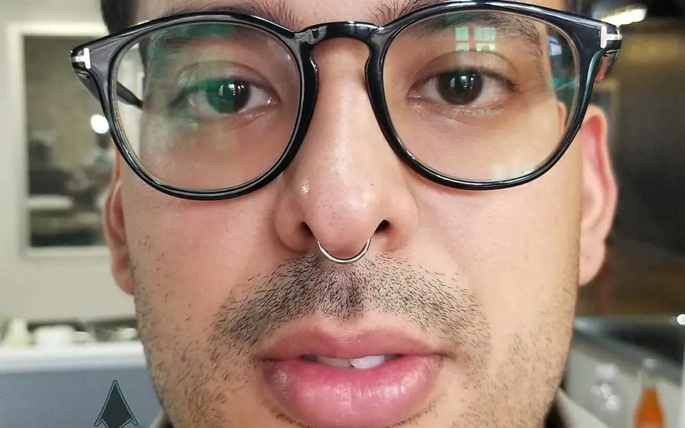 man with septum-piercing-jewelry and glasses